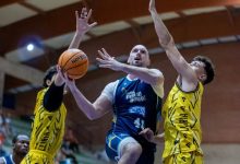 Jugador Molina basket en medio tratando de encestar con dos jujadores contrarios